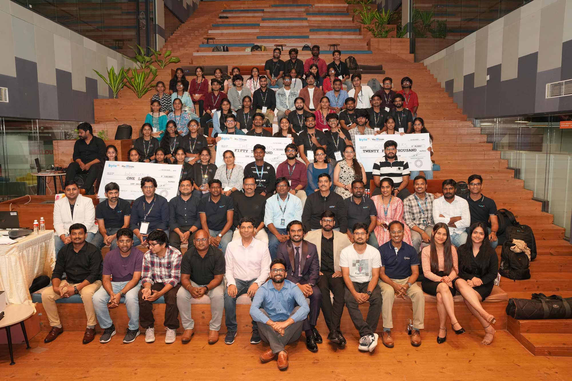 The HacXLerate community group photo on the auditorium steps
