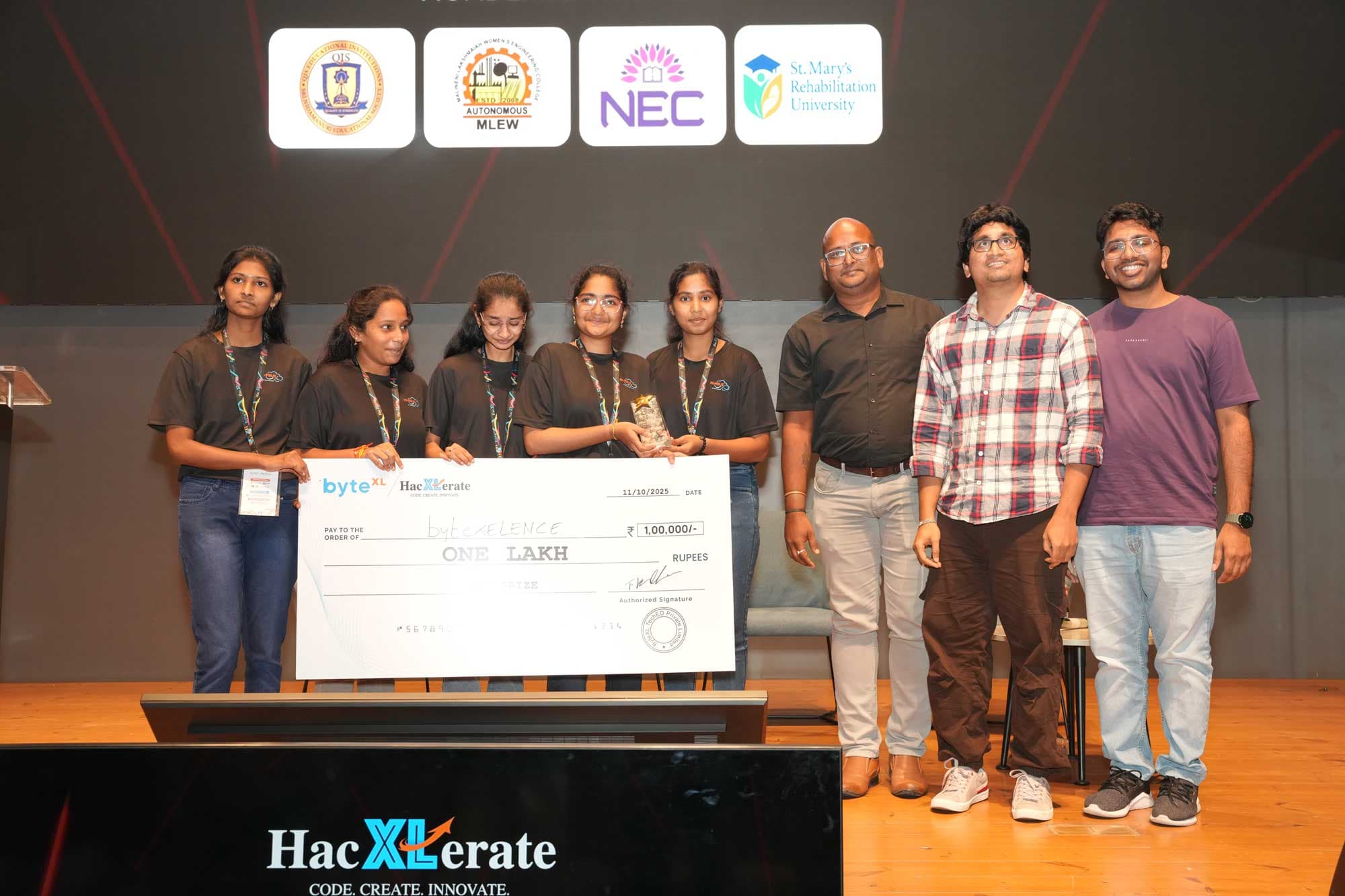 A winning team receiving a ₹1,00,000 prize cheque