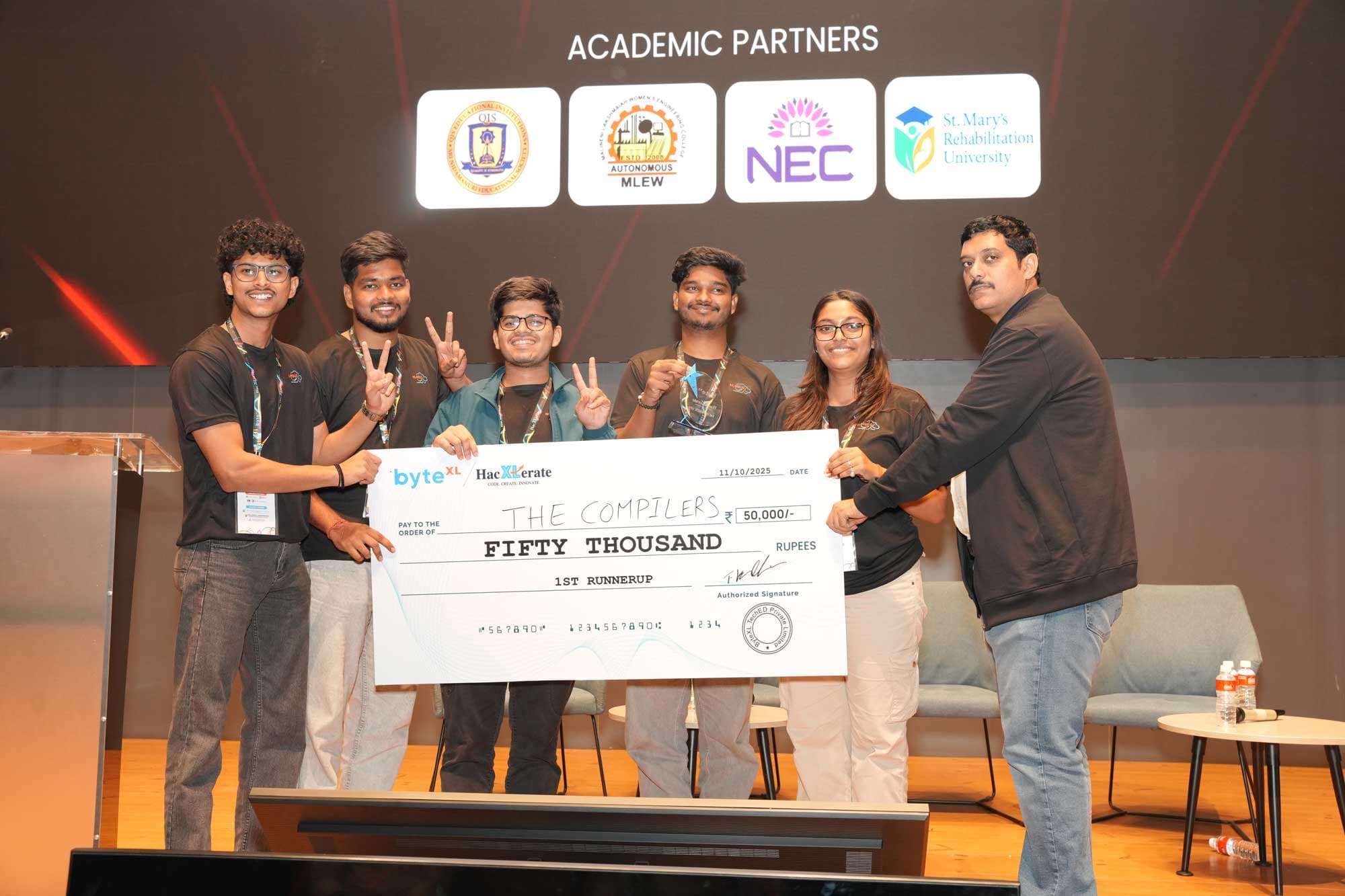 Team The Compilers receiving a ₹50,000 prize cheque